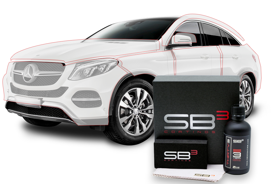 A white car is sitting next to a box of sb3 coating.