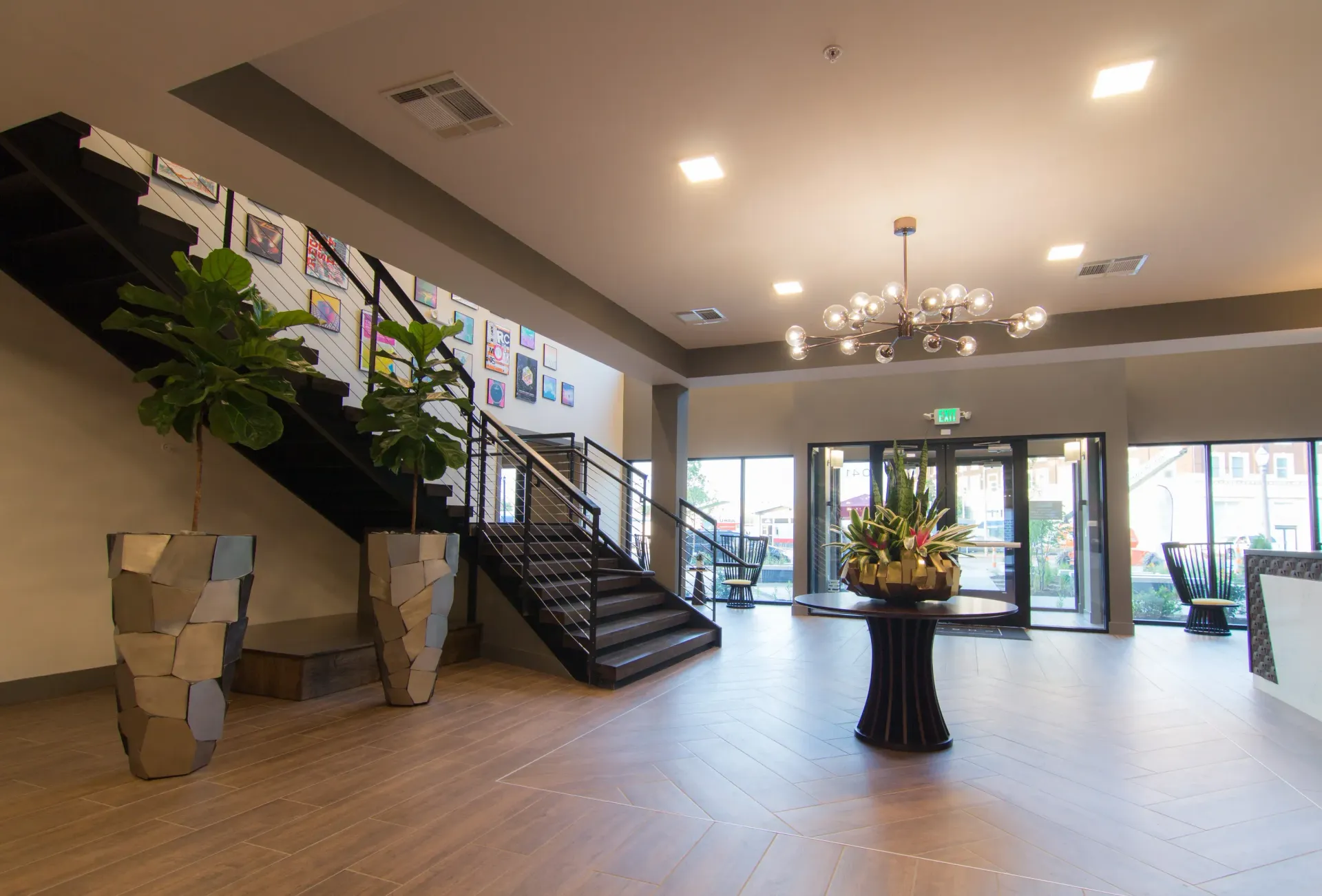 Person laughing, head tilted back, brown hair, wearing a green shirt, against a white background.