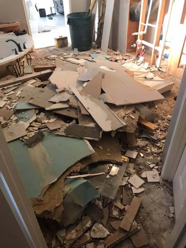 A room with a lot of broken pieces of wood on the floor.