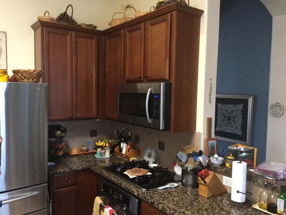A kitchen with stainless steel appliances and wooden cabinets