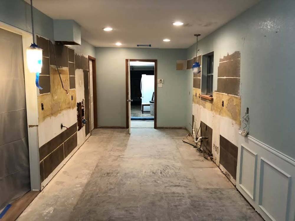 A long hallway in a house that is being remodeled.