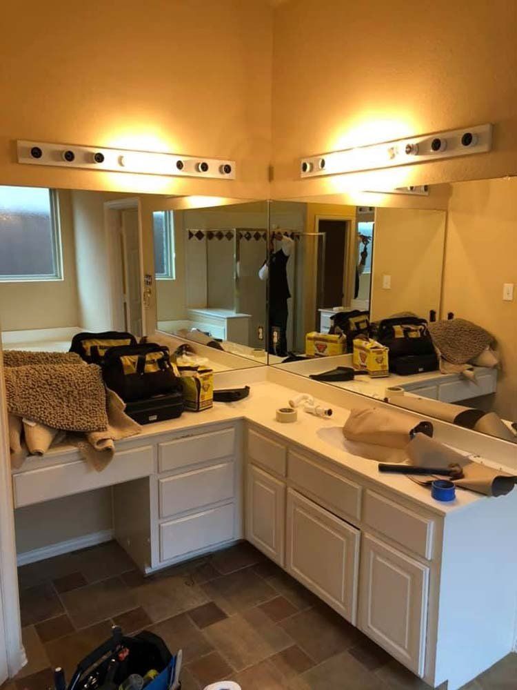 A bathroom with two sinks and a large mirror.