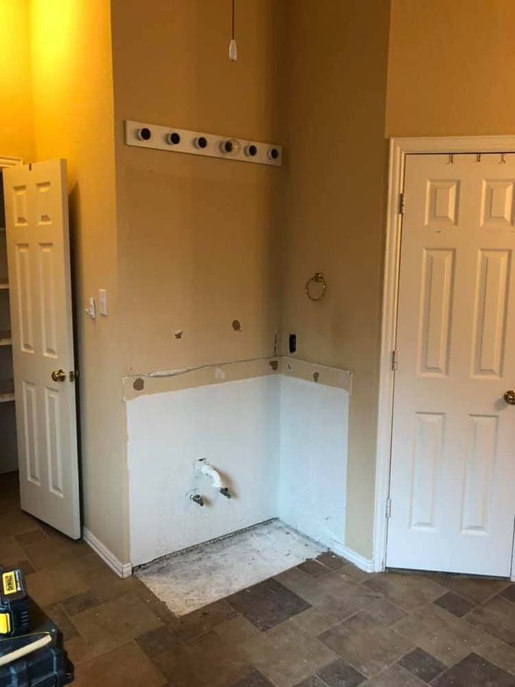A bathroom with a bathtub in the corner of the room.