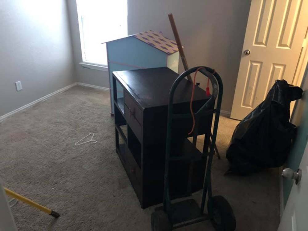A room with a table and a cart in it