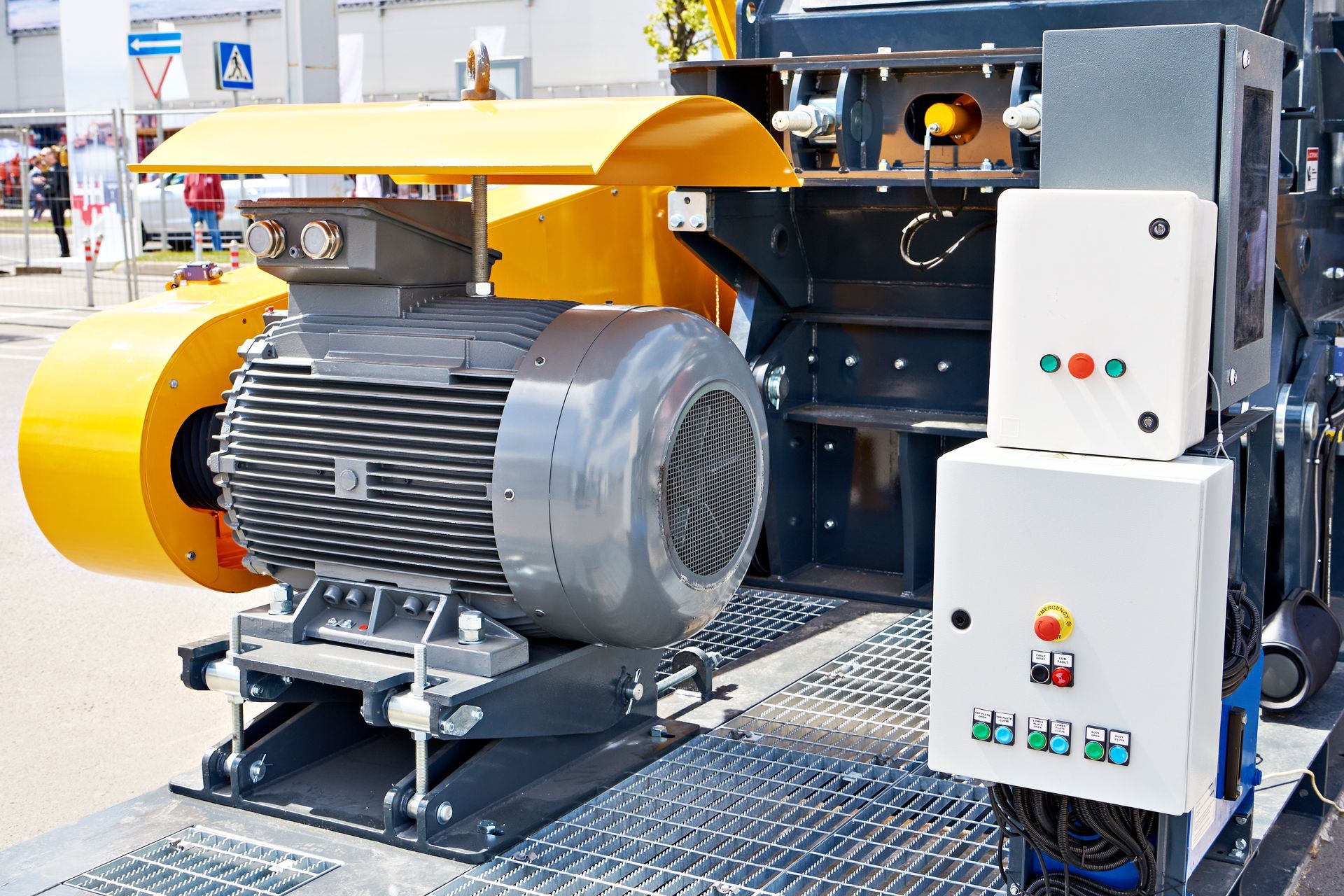 Industrial motor and machinery with yellow housing and control panels in a factory setting. Industrial motor and machinery with yellow housing and control panels in a factory setting.
