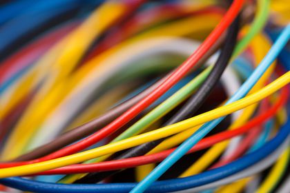 Close-up of tangled multicolored electrical wires and cables. Close-up of tangled multicolored electrical wires and cables.