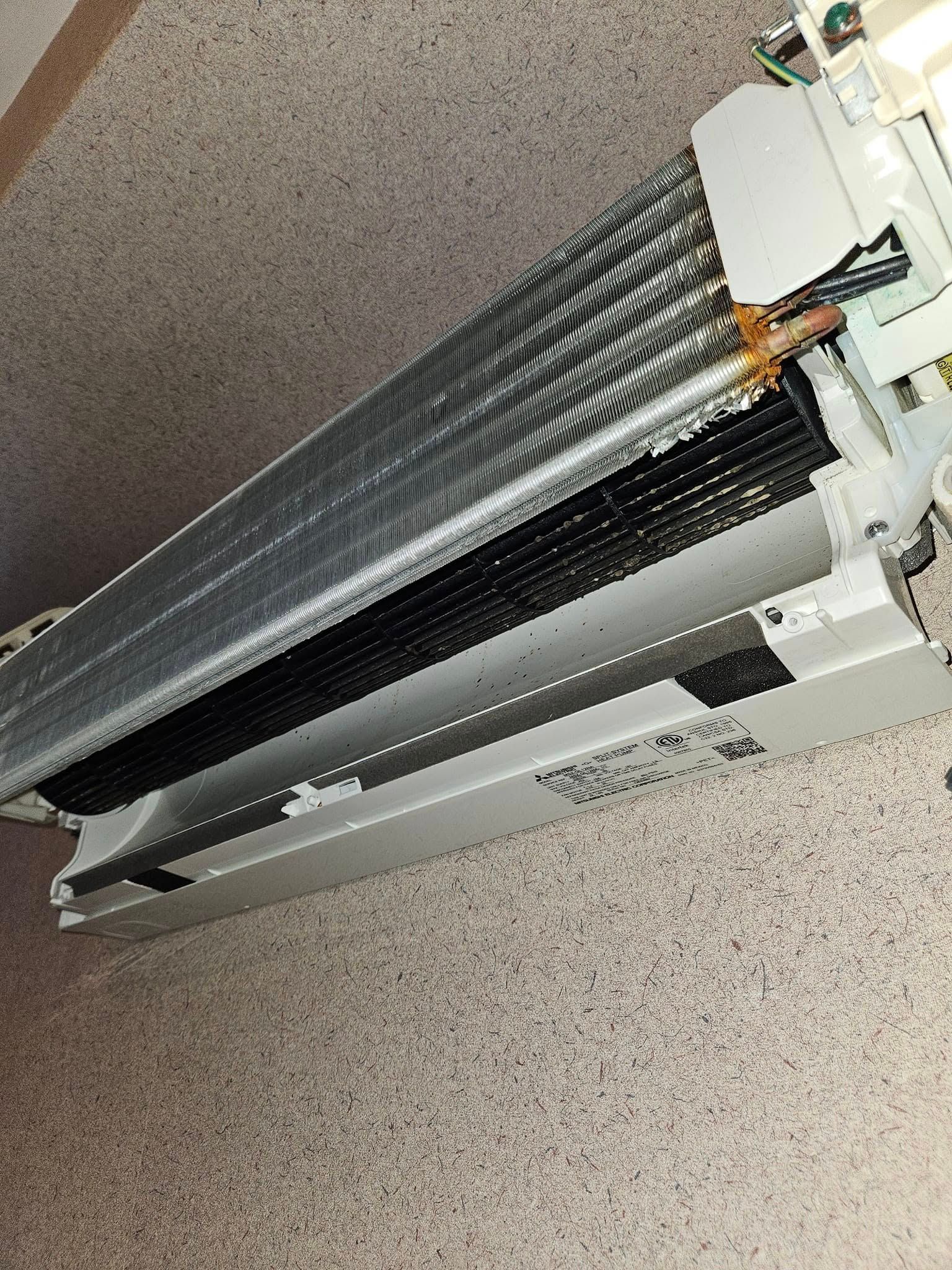Kenders Heating And Air Conditioning | a close up of an air conditioner on a wall.