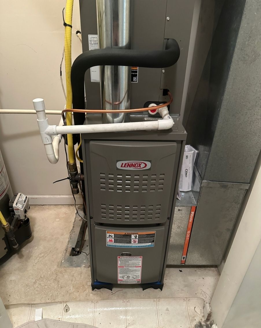 Kenders Heating And Air Conditioning | a lennox furnace is sitting in a room next to a refrigerator.