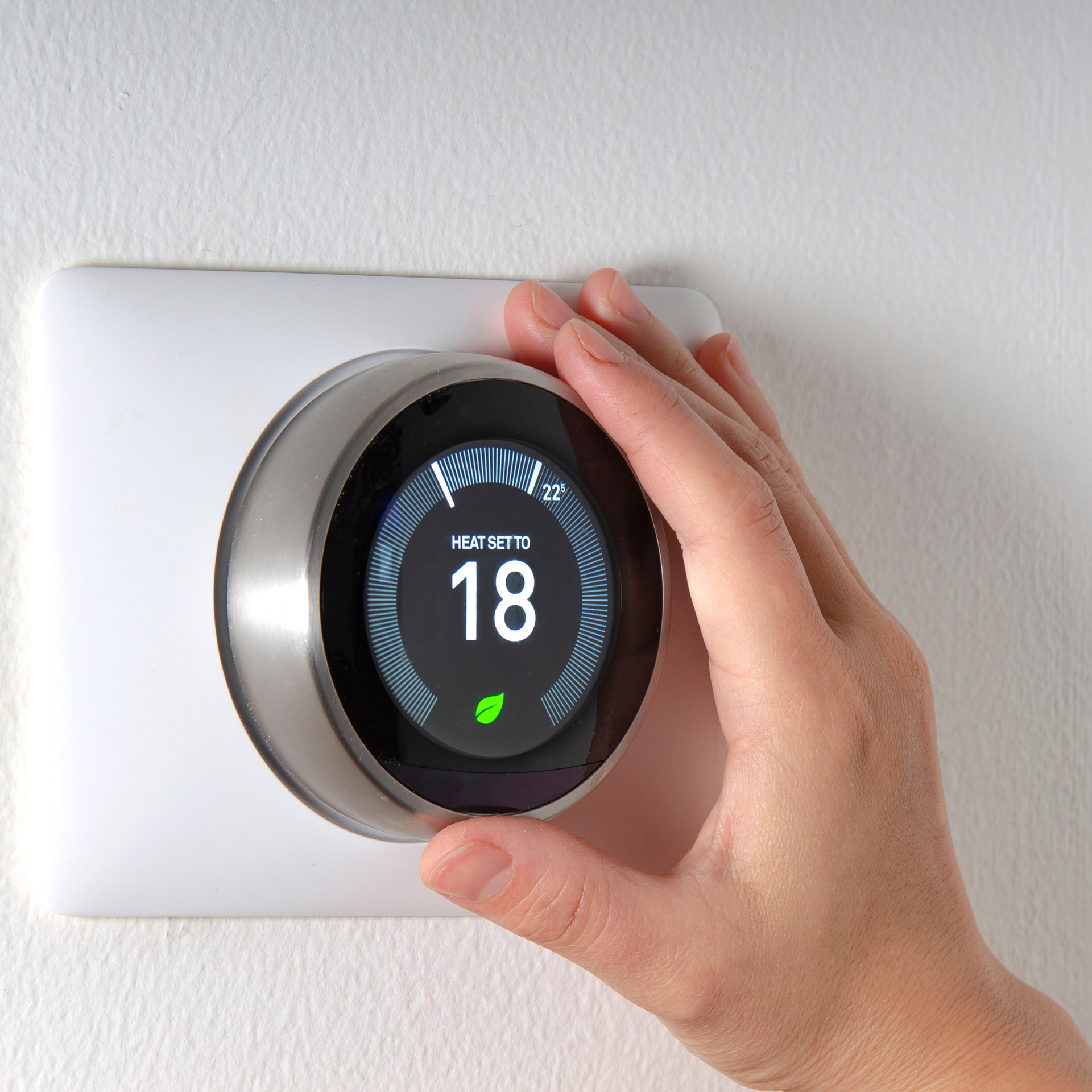 Kenders Heating And Air Conditioning | a person is holding a thermostat with the number 18 on it