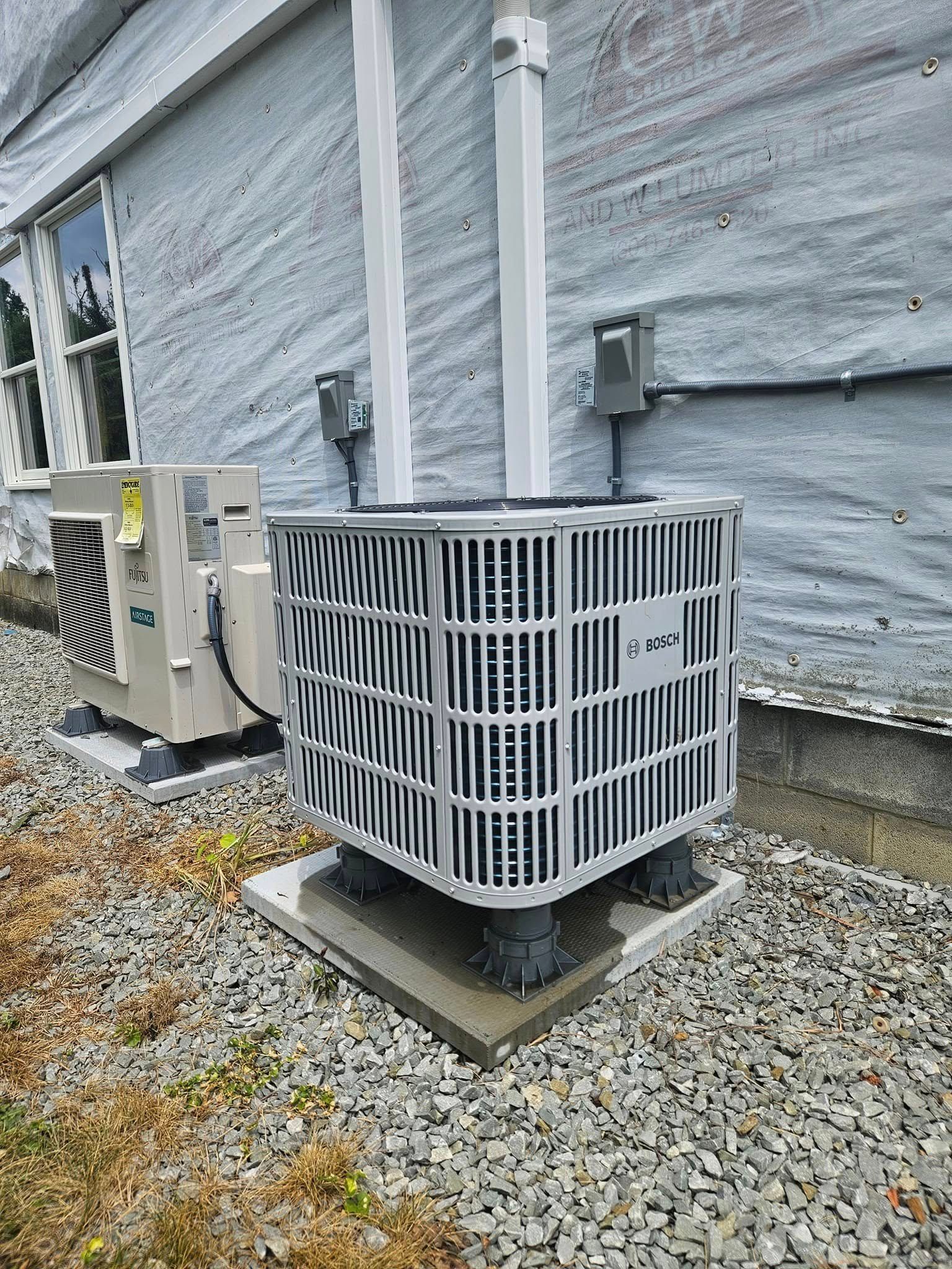 Kenders Heating And Air Conditioning | a large air conditioner is sitting on the side of a house.