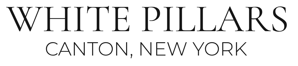 White Pillars logo: text reads 