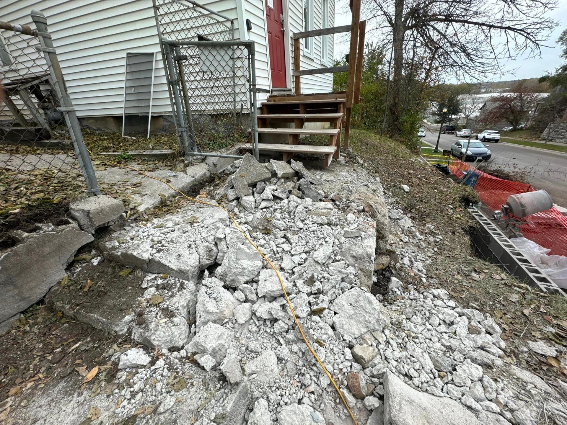 A pile of rocks is sitting in front of a house.