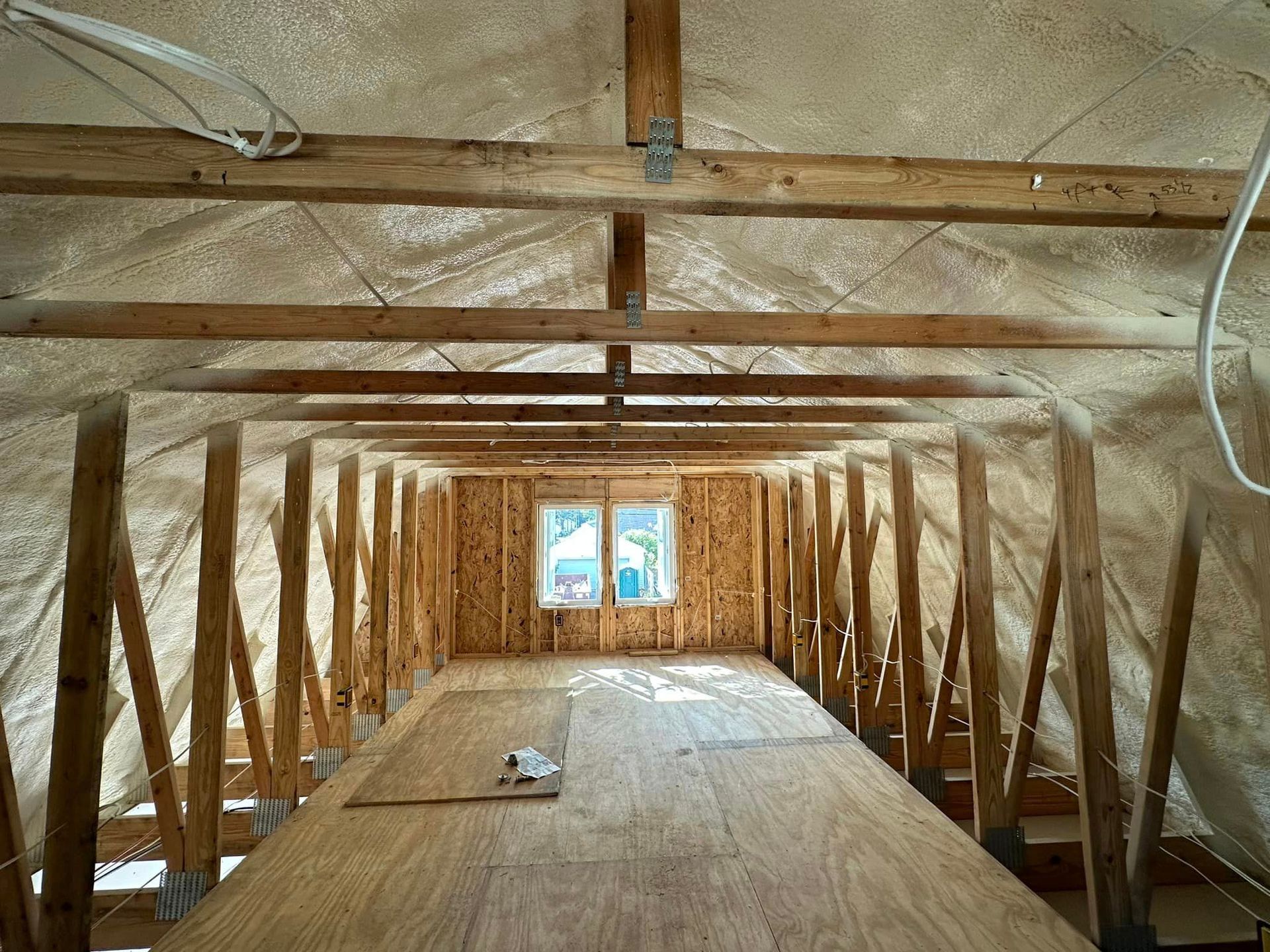 A room with a lot of wooden beams and a wooden floor.