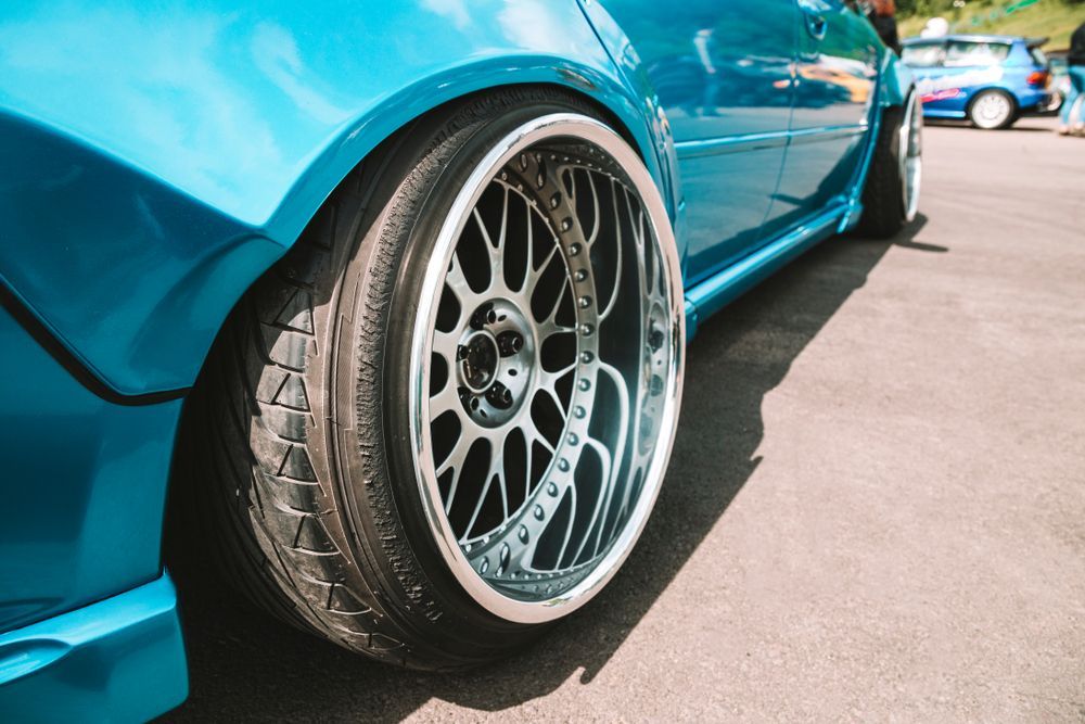Blue Car With Chrome Rims, Tires Close to the Wheel Well — Old Mate's Towing Townsville in Deeragun, QLD