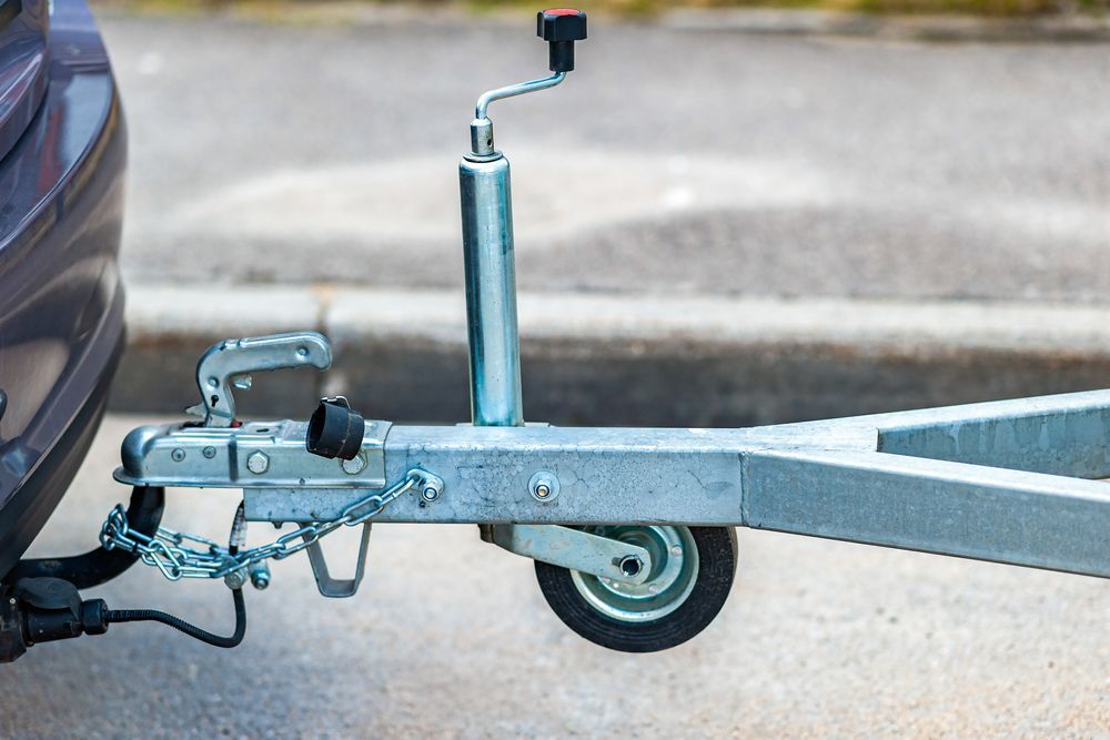 Car Hitched to a Trailer with Metal Components — Old Mate's Towing Townsville in Deeragun, QLD