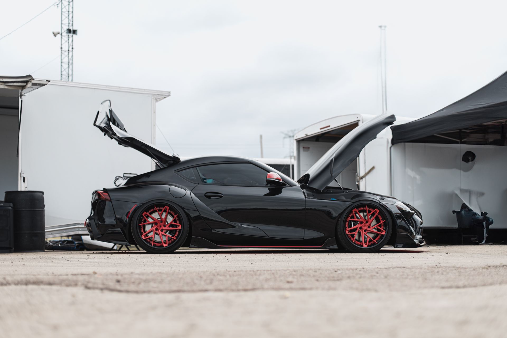 Black Sports Car With Red Rims — Old Mate's Towing Townsville in Deeragun, QLD