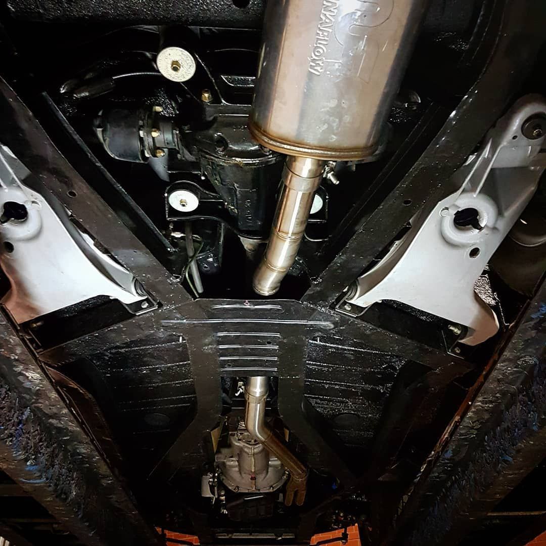 A Close Up Of The Underside Of A Car With A Exhaust Pipe Coming Out Of It - Mechanic In Fyshwick, ACT