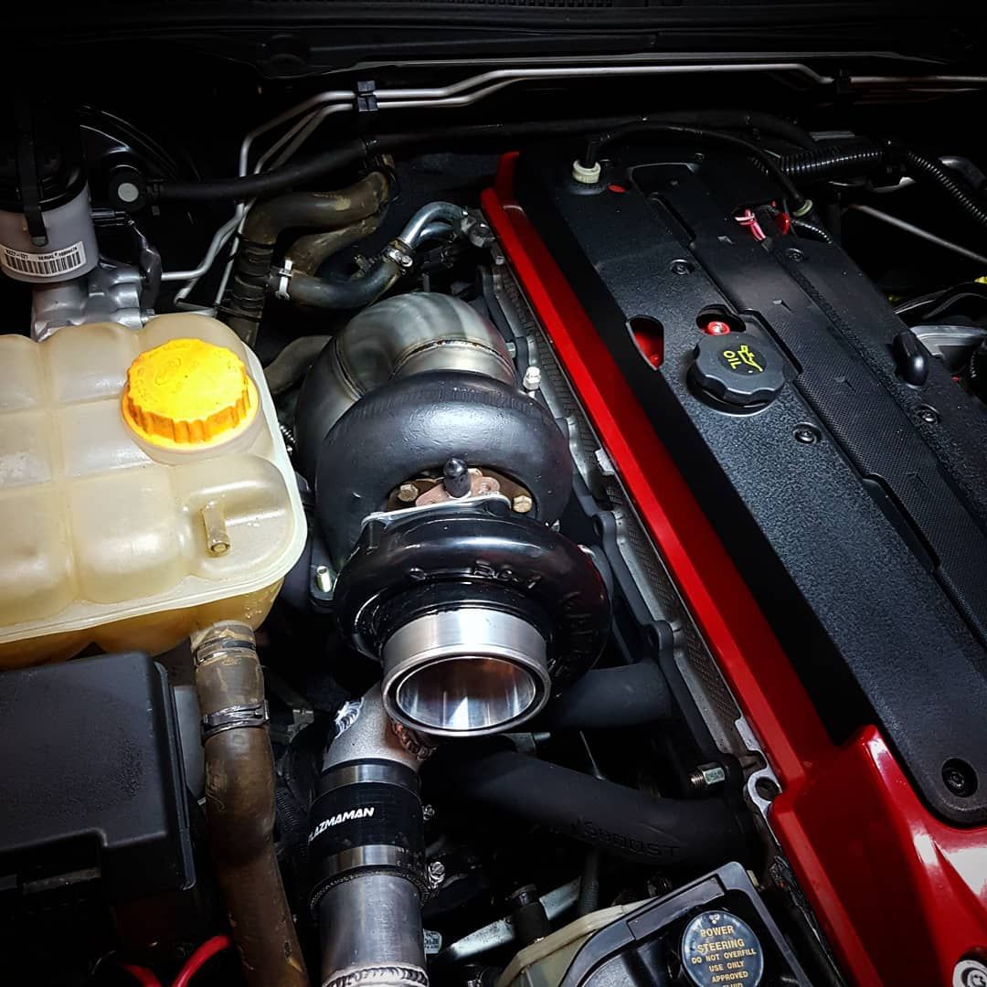 A Close Up Of A Car Engine With A Yellow Cap On It - Mechanic In Fyshwick, ACT