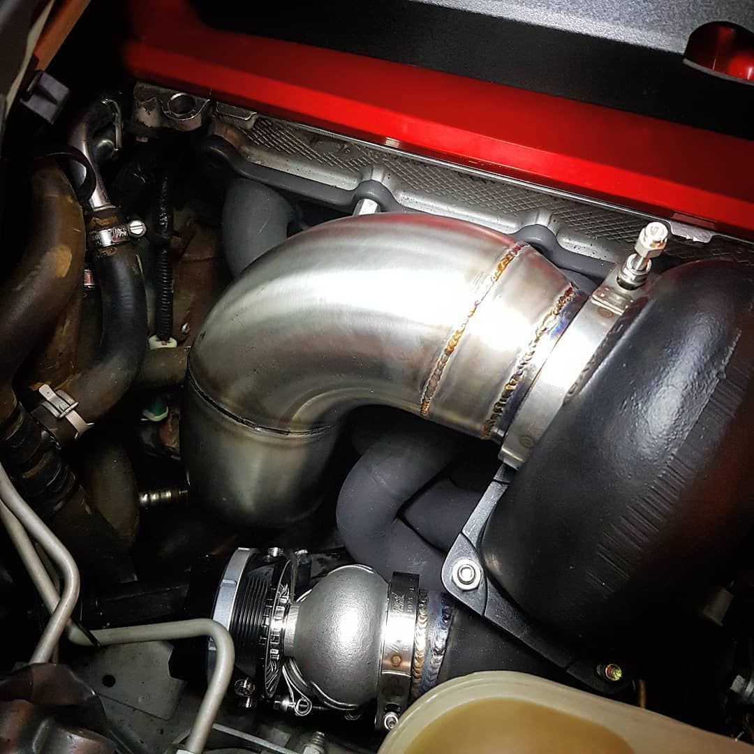 A Close Up Of A Stainless Steel Pipe In A Car Engine - Mechanic In Fyshwick, ACT