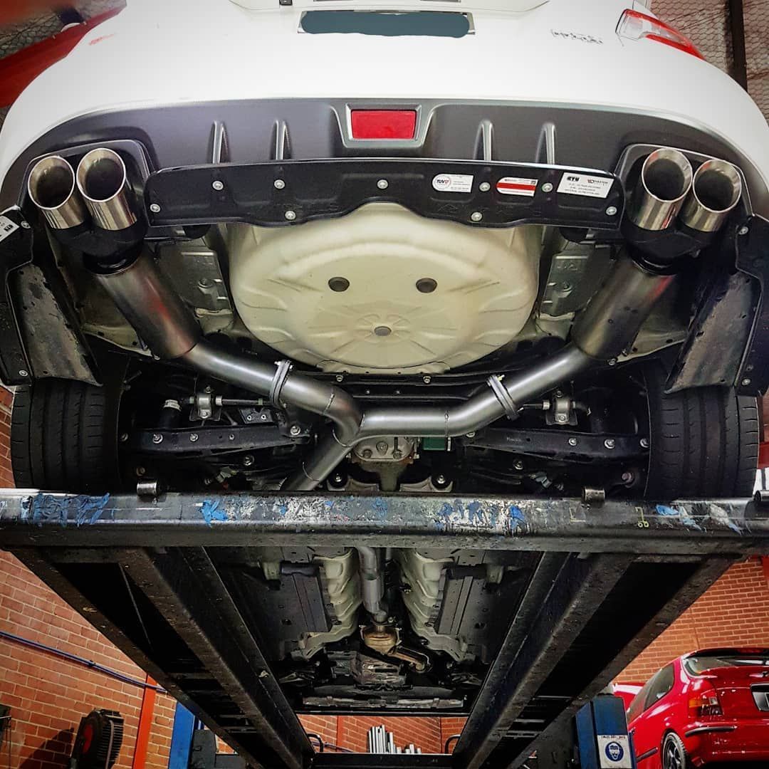 The Underside of a White Car with Exhaust Pipes - Mechanic in Fyshwick, ACT