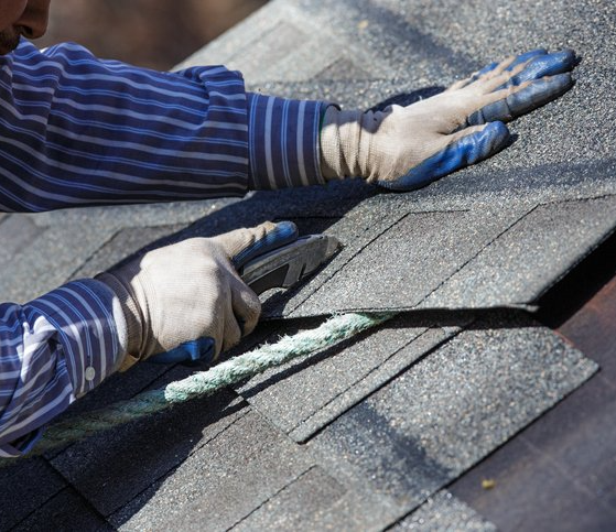 Contractor Cutting Shingle