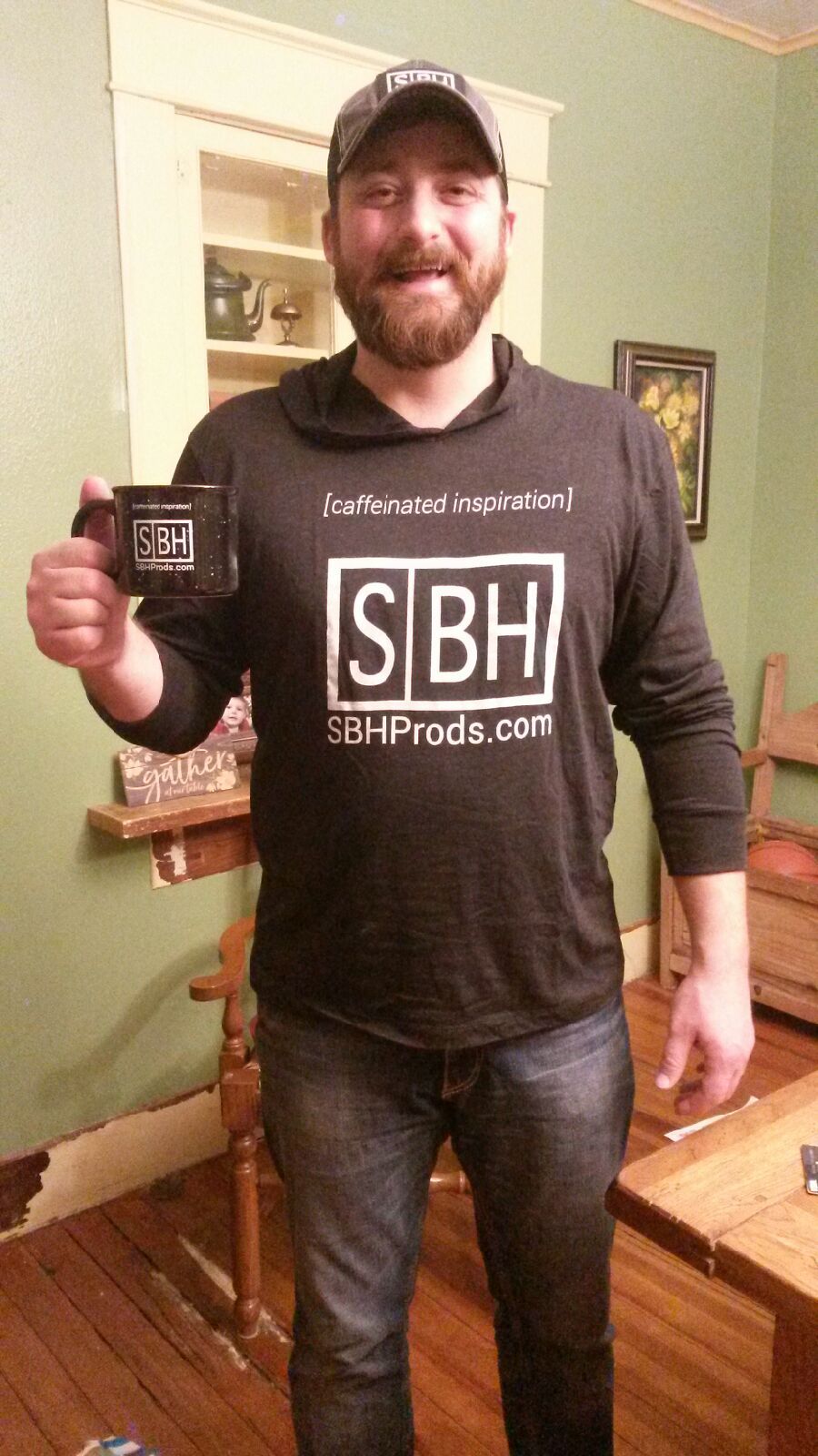 travis palmer holding coffee mug sporting studiobeanhead swag