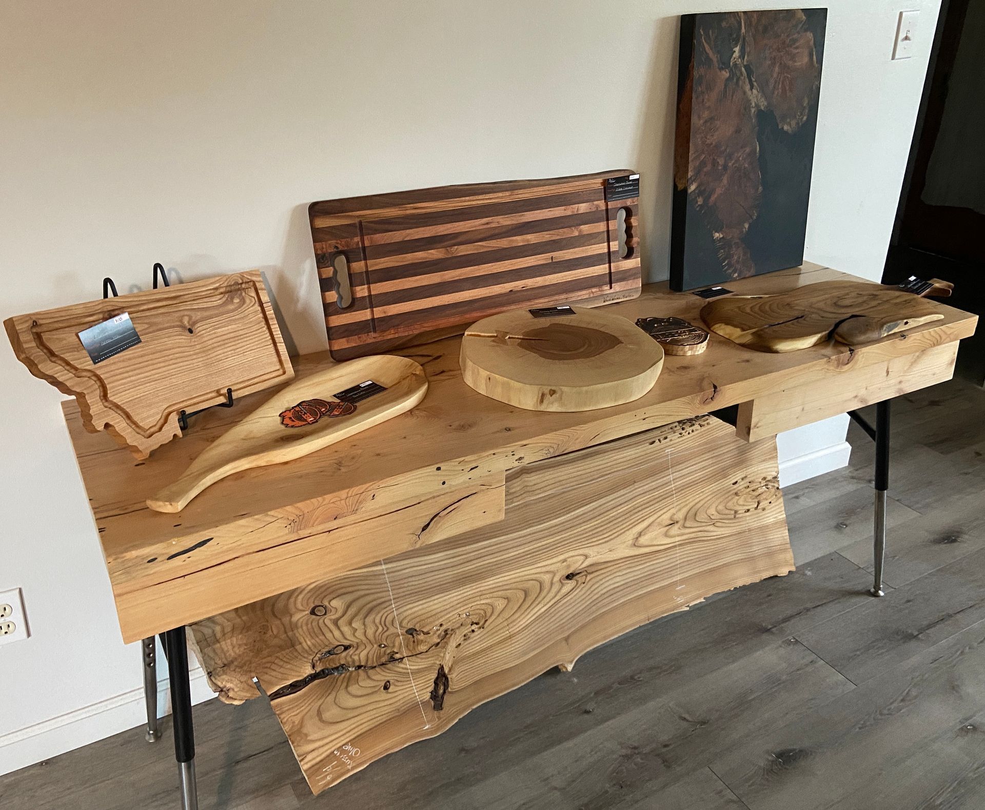 Wooden serving boards and cutting boards displayed on a table.