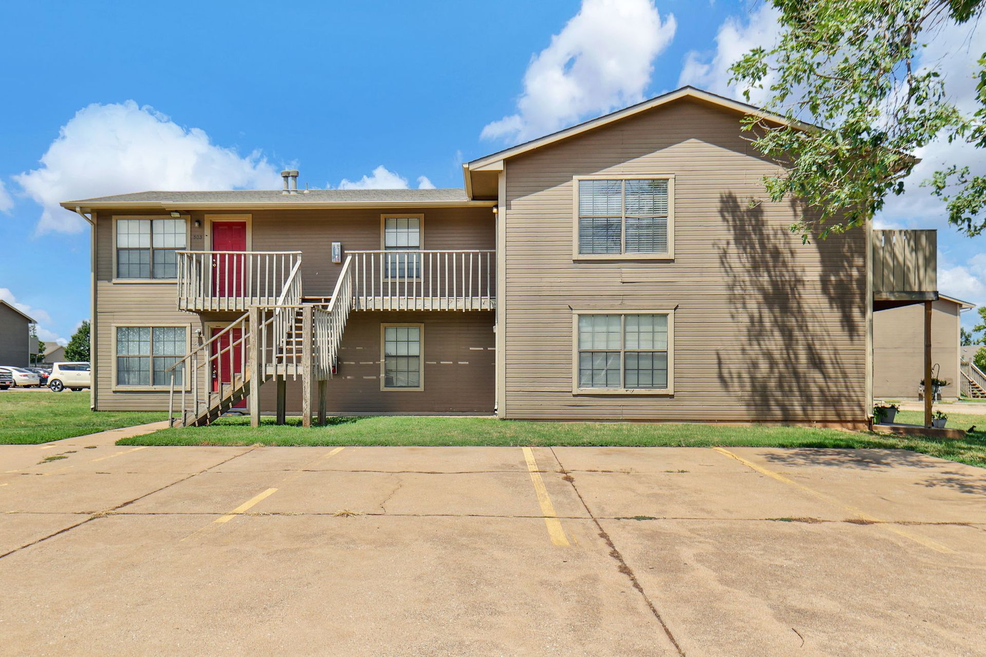 A large apartment building with stairs leading up to the second floor