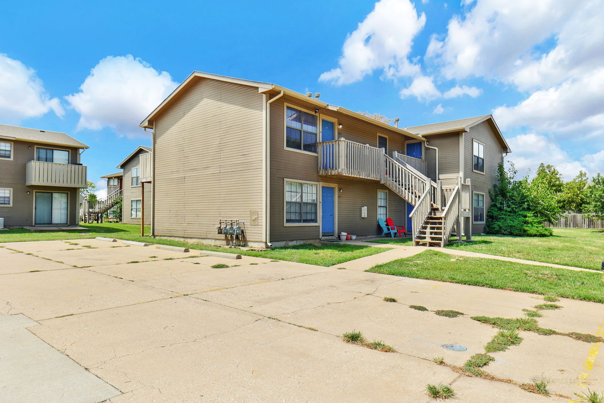 A large apartment building with stairs leading up to the second floor.