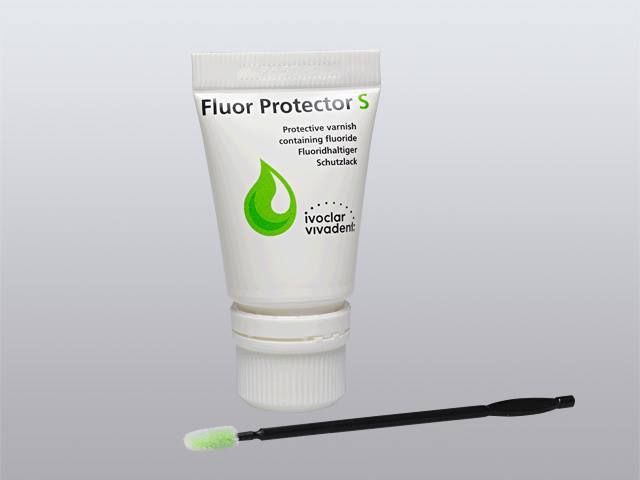 Tubetto bianco di vernice al fluoro Fluor Protector S con pennello applicatore.