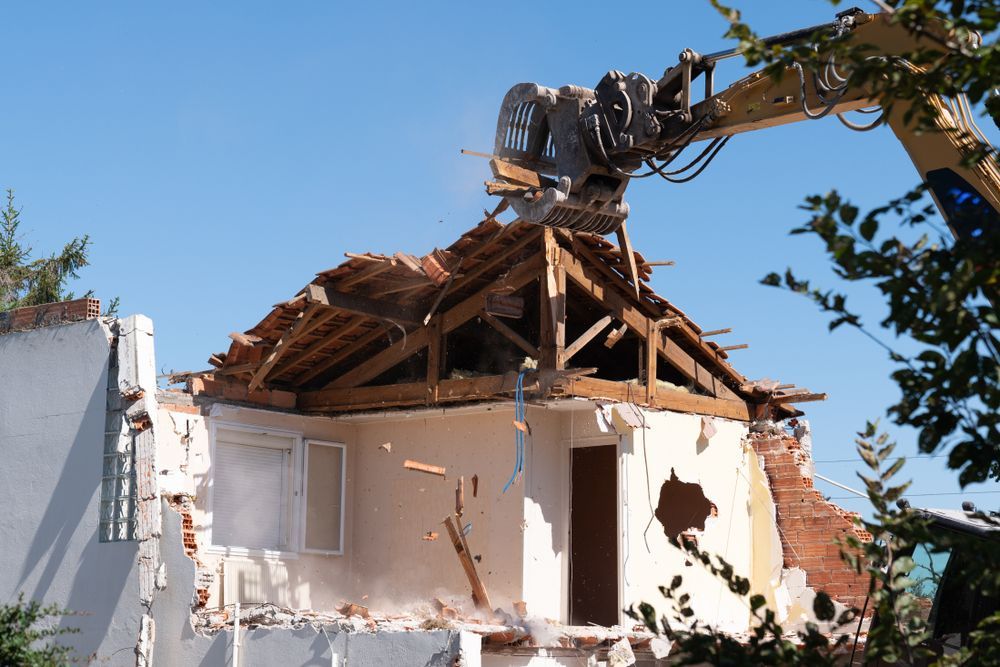 A House is Being Demolished by a Large Excavator — Gears Excavation In Cedar Pocket, QLD