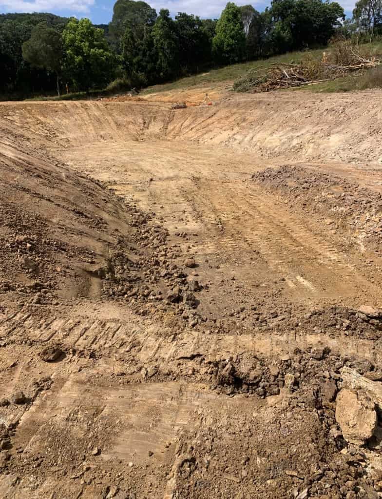 A Large Dirt Field With Trees in the Background — Gears Excavation In Cedar Pocket, QLD