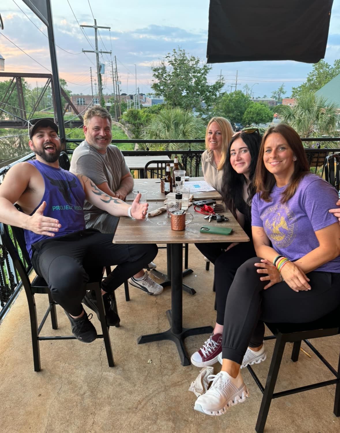 Dakota Brokhoff sitting at a table on a balcony with Kenny Witten