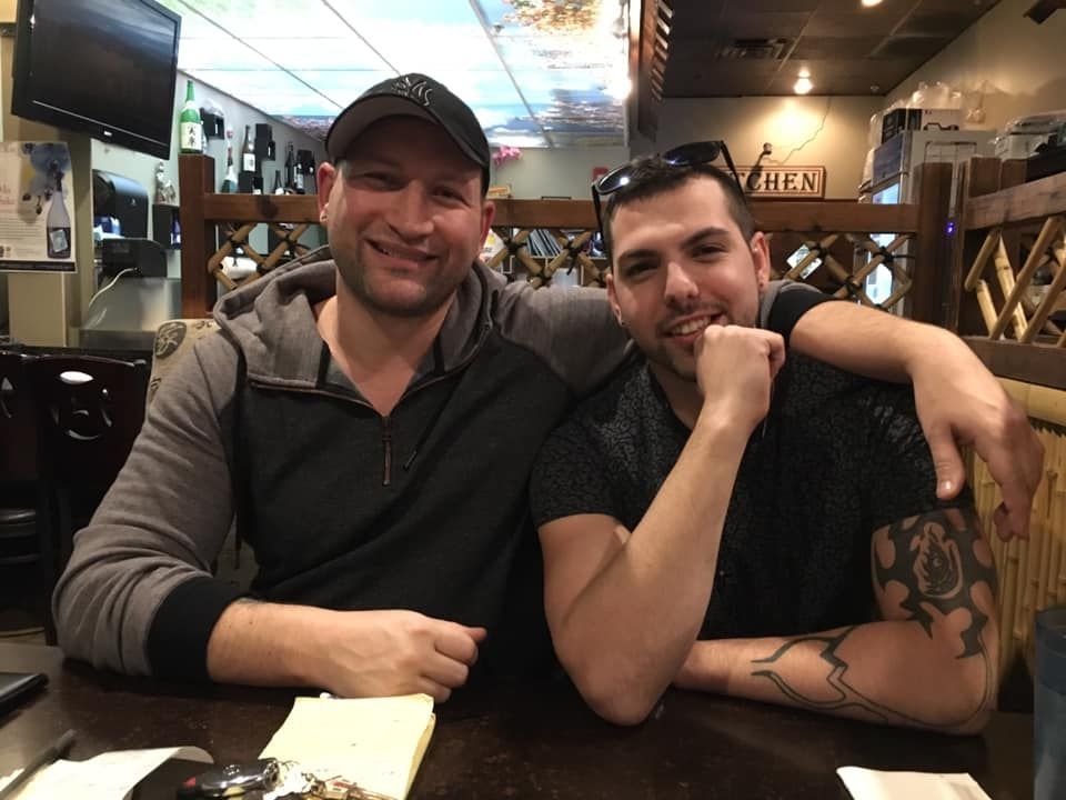 Dakota Brokhoff sitting at a table with Aaron Regdos