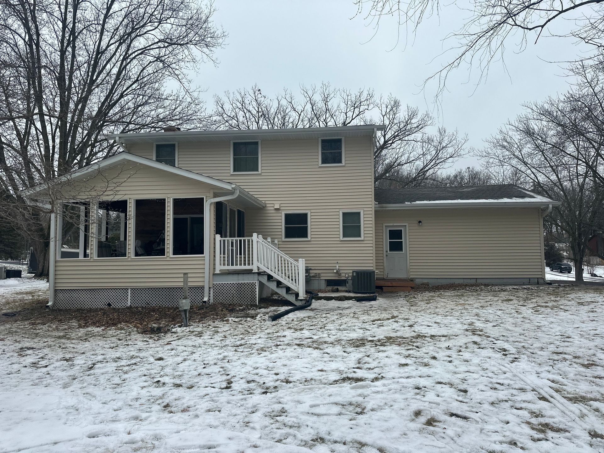 A House with A Porch and Stairs in The Snow — Carver, MN — TJ Exteriors Inc.