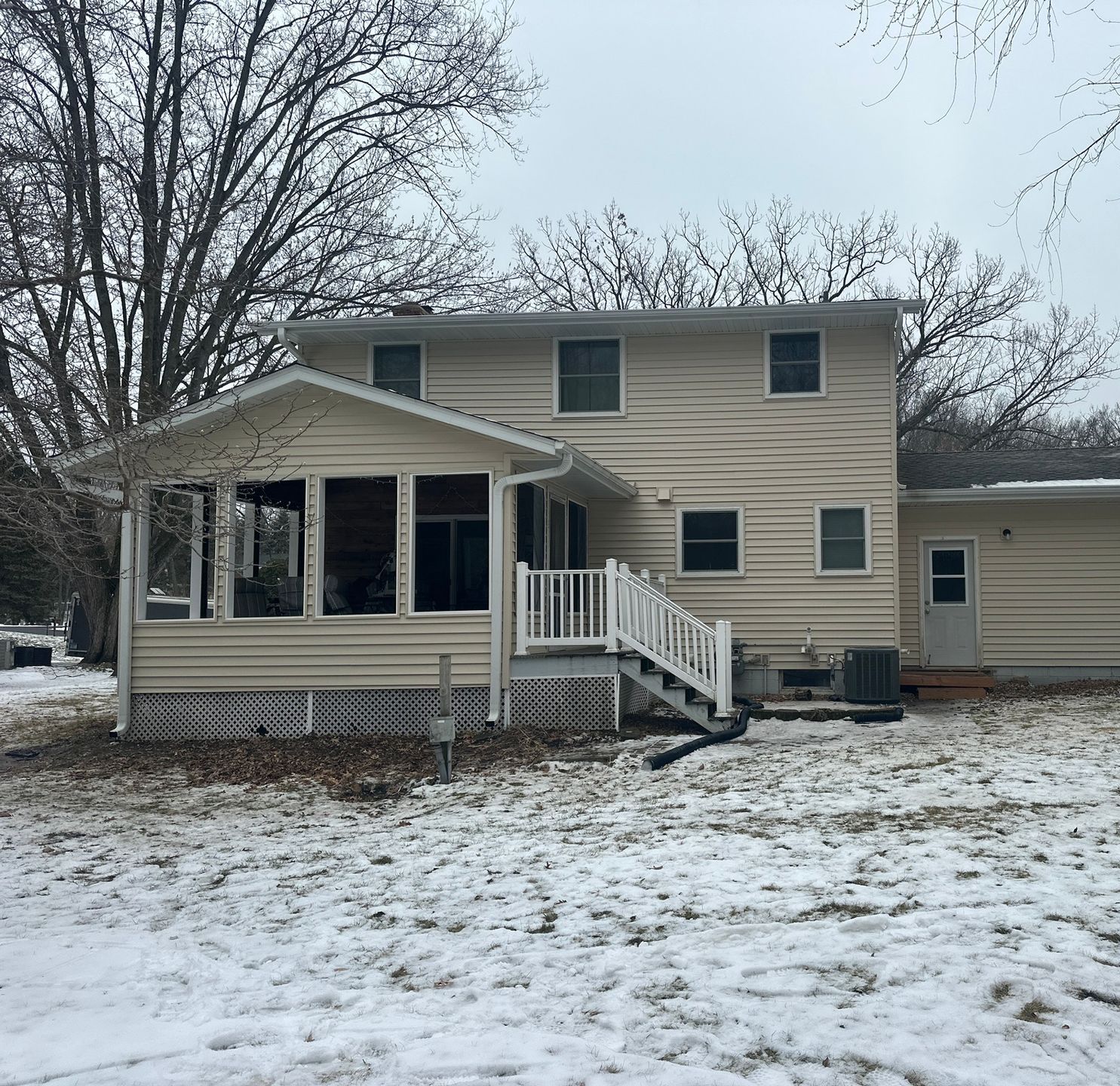 A House with A Porch and Stairs in The Snow — Carver, MN — TJ Exteriors Inc.