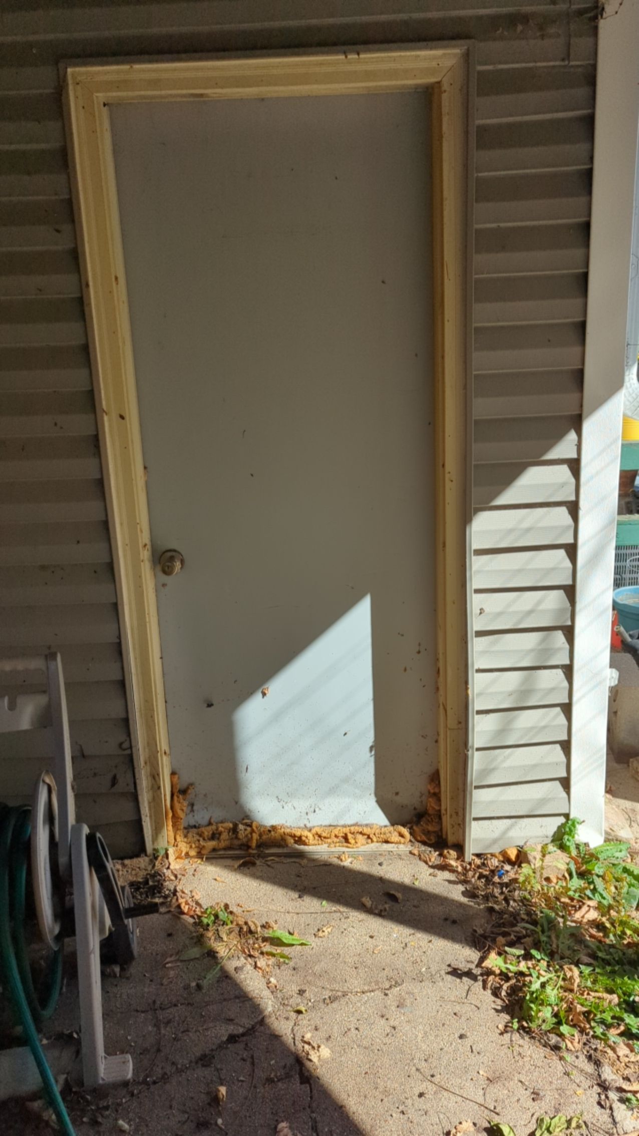 A door is being installed on the side of a house.