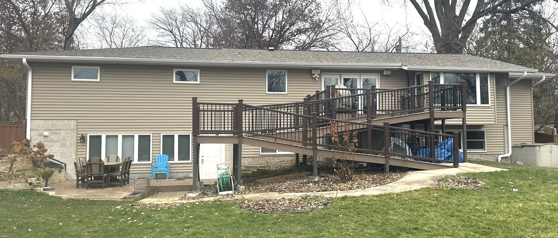 The back of a house with a large deck and a ramp.