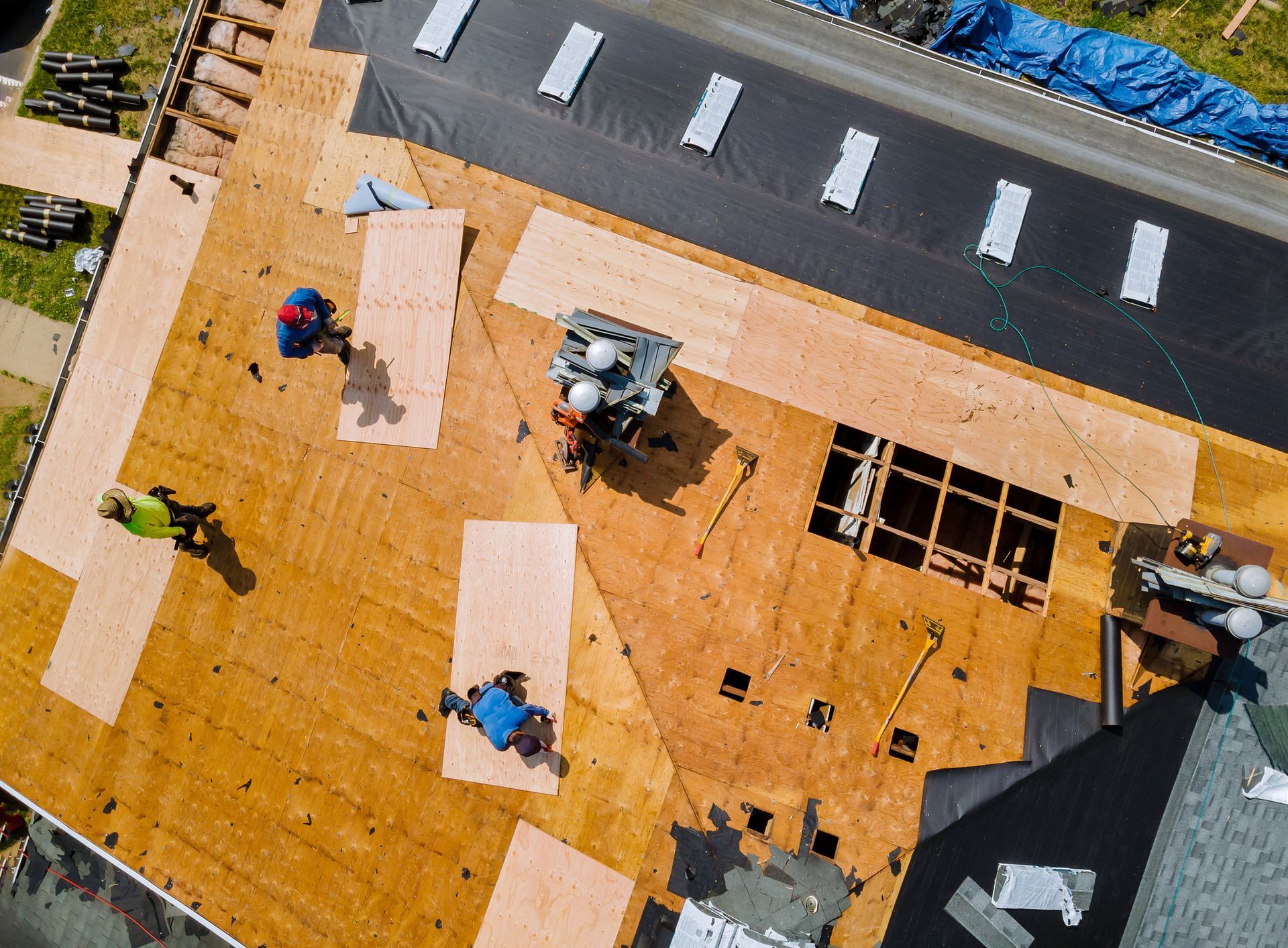 Professional Roof Replacement — Workers installing new roof.