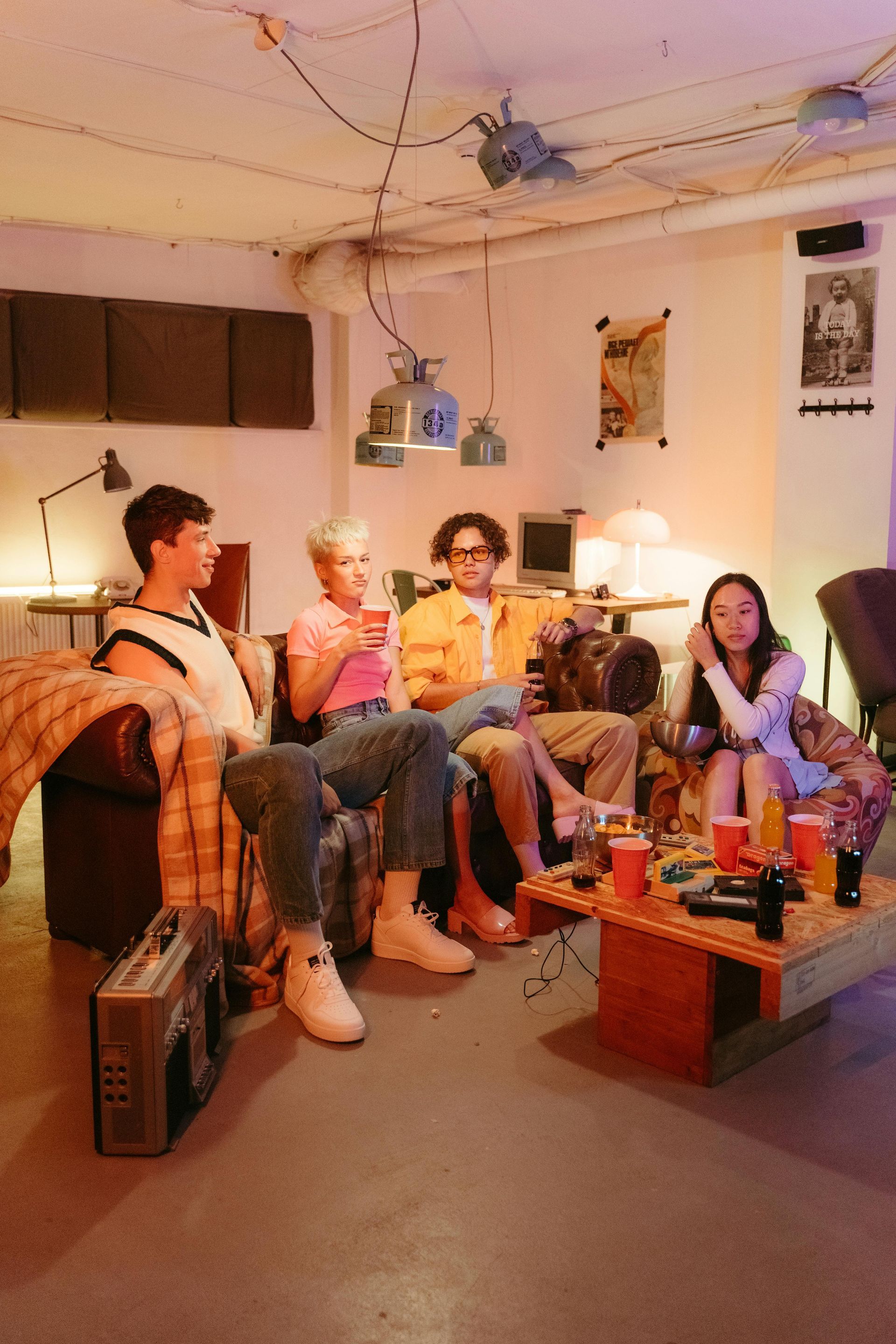 A group of people are sitting around a table in a living room.