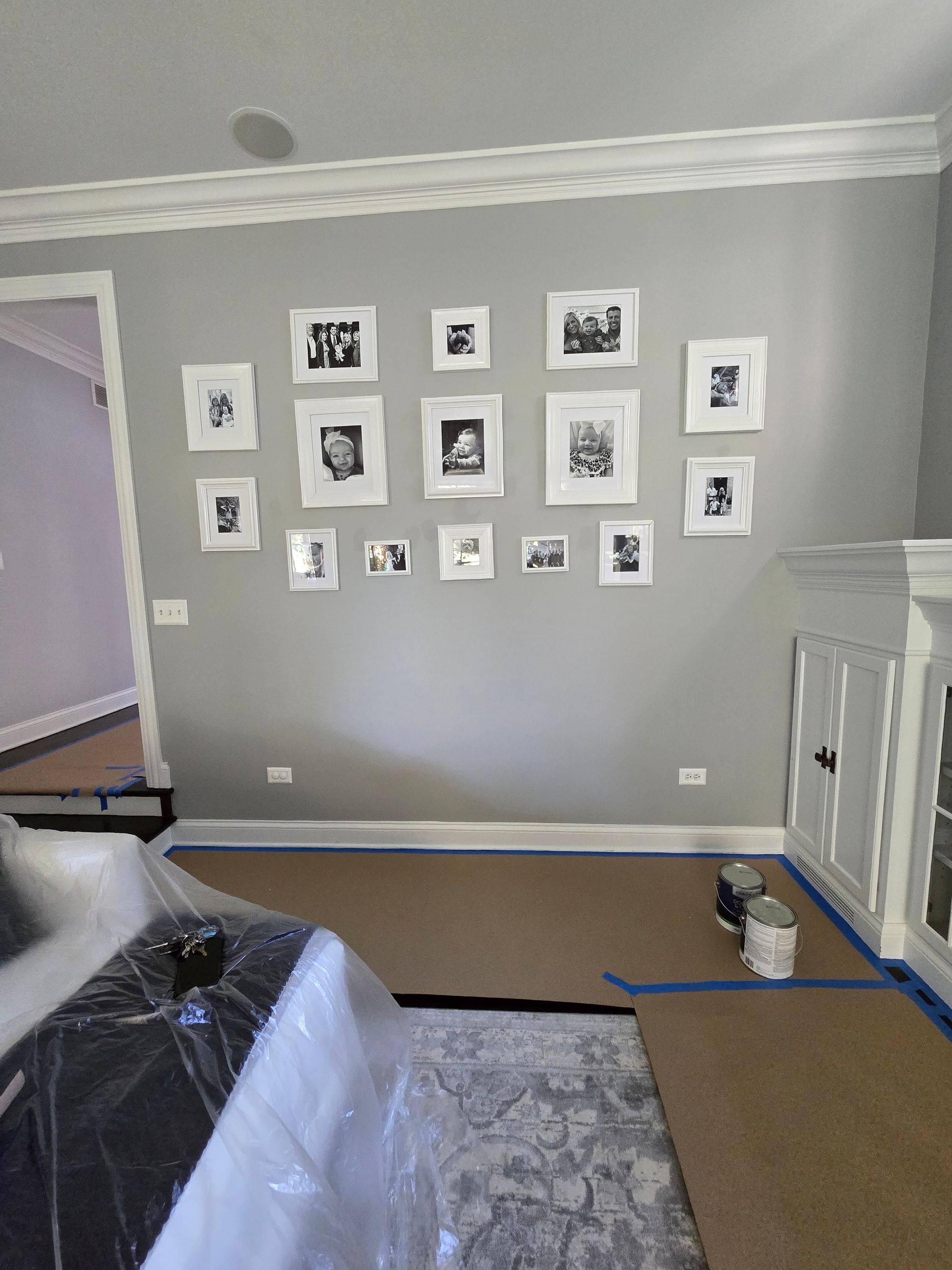 A living room with a lot of pictures on the wall.