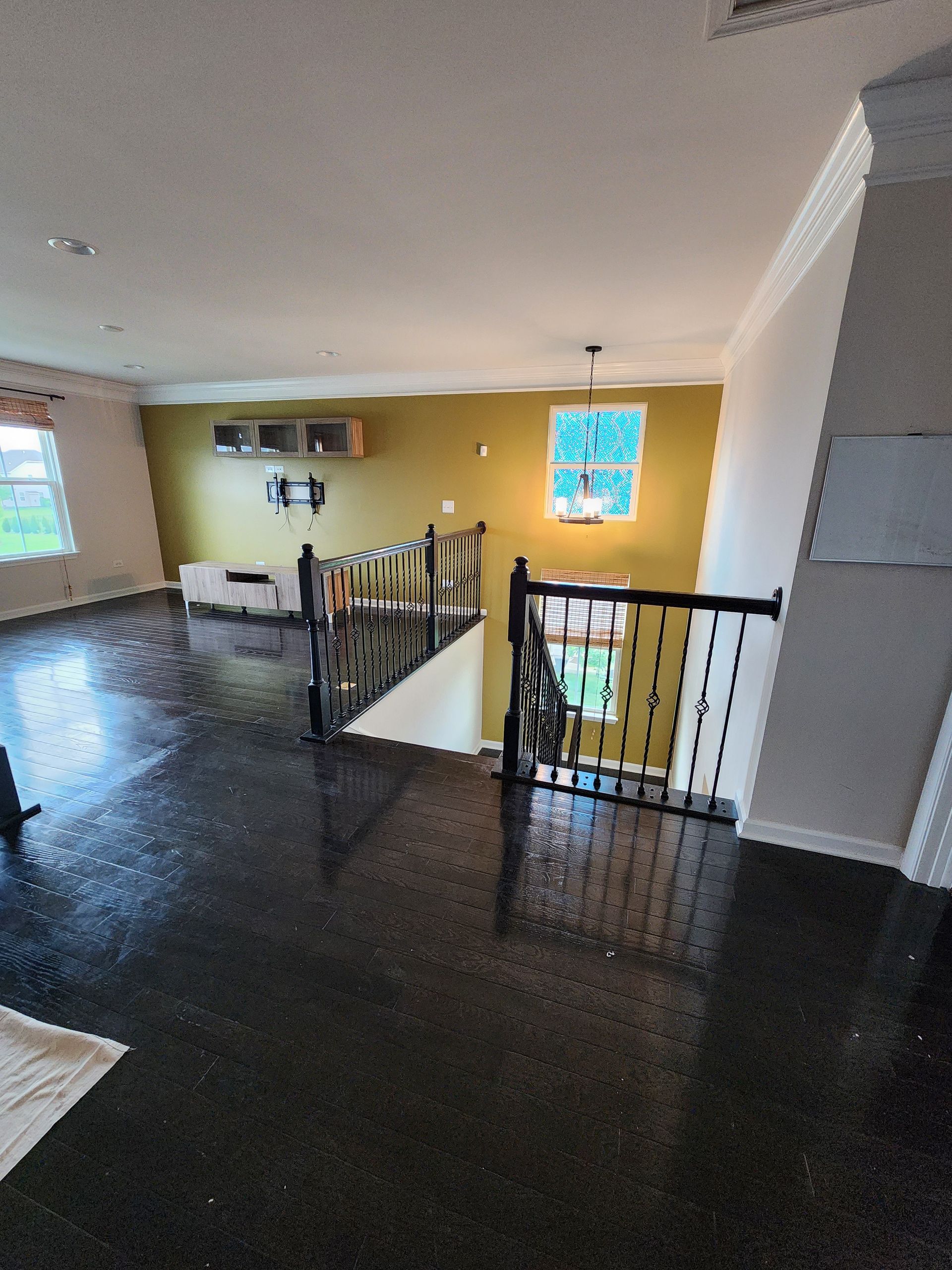 A living room with a staircase leading up to the second floor.