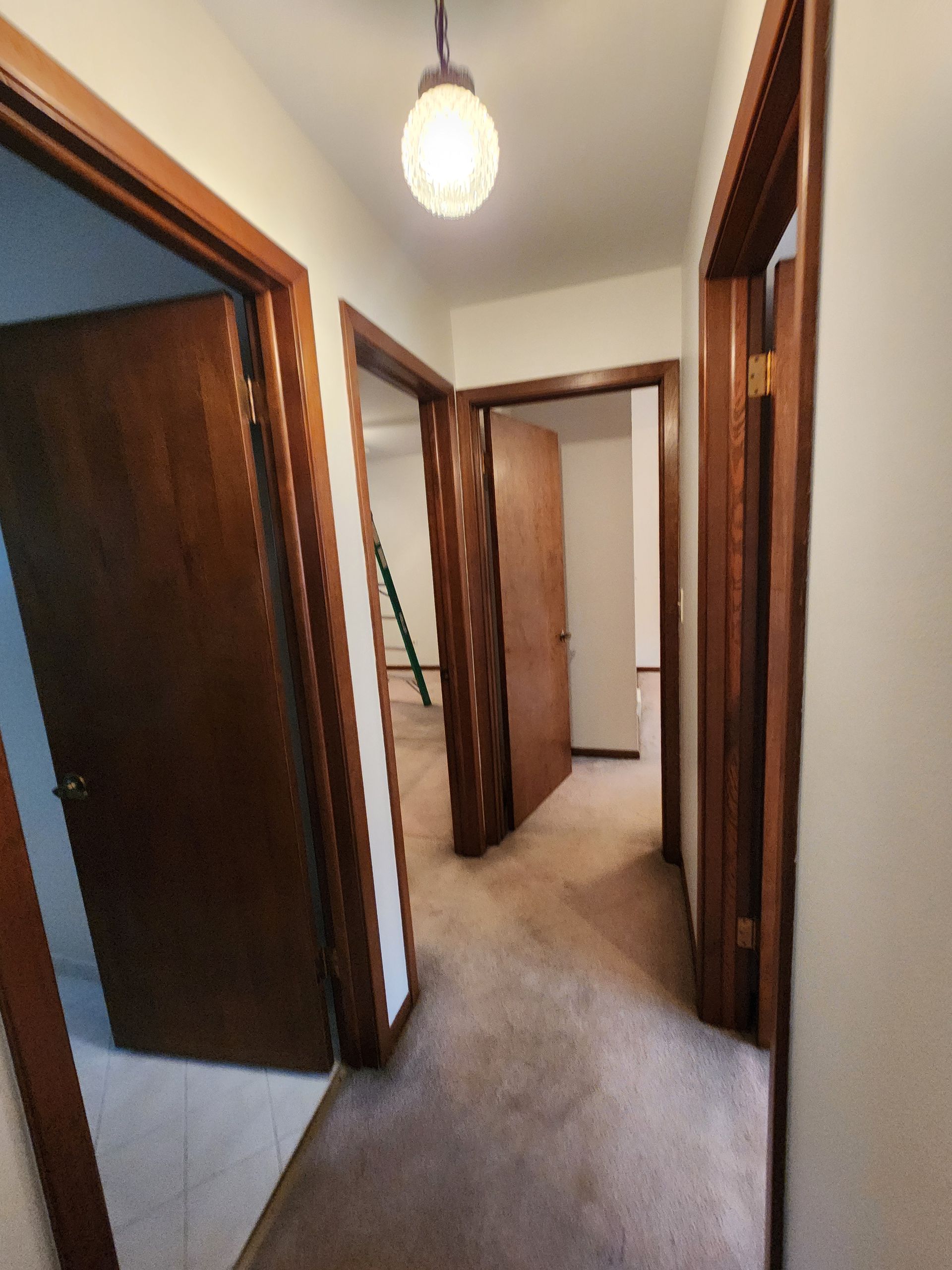 A hallway with a light hanging from the ceiling