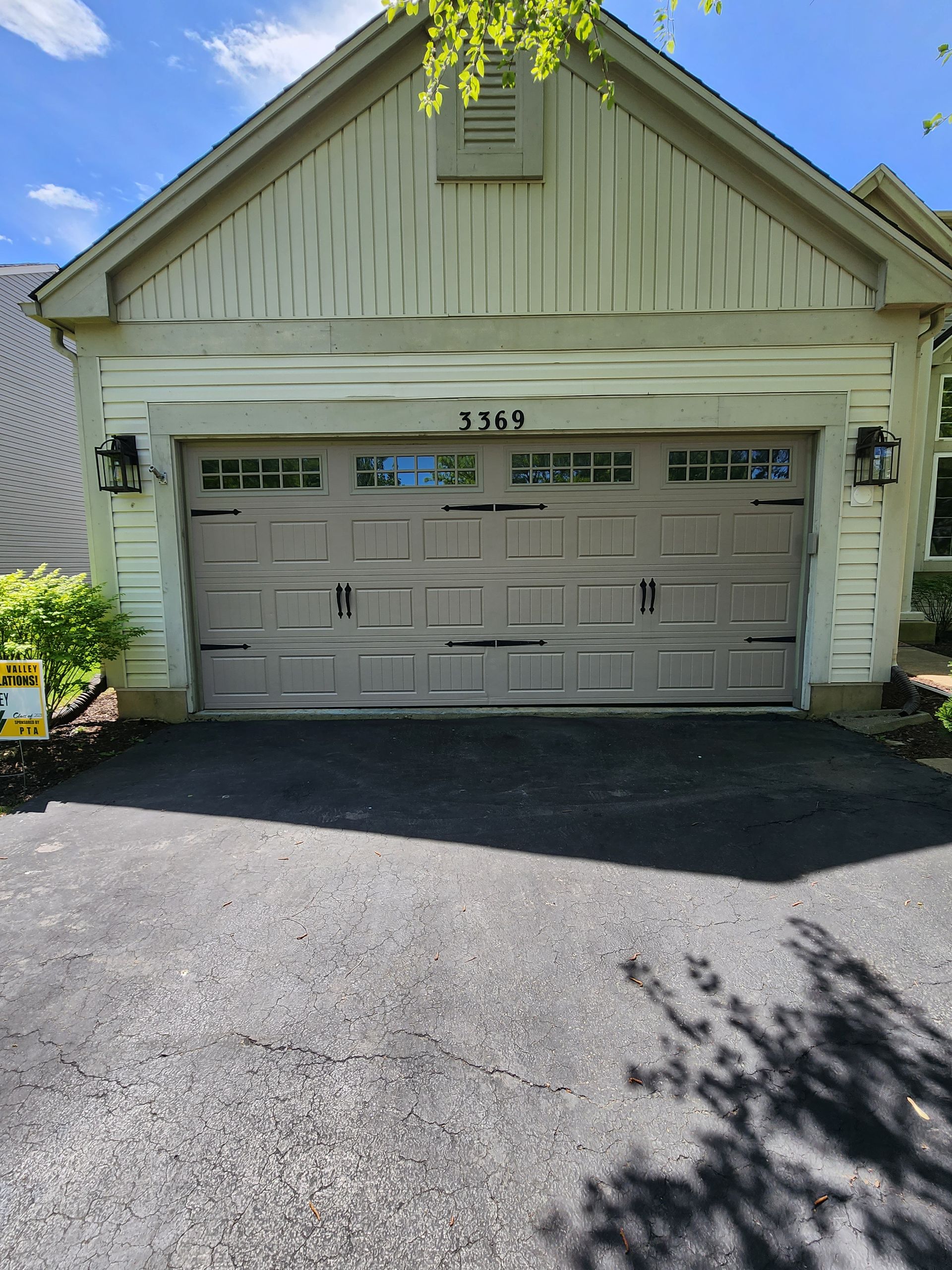 A large garage door is sitting in front of a house.