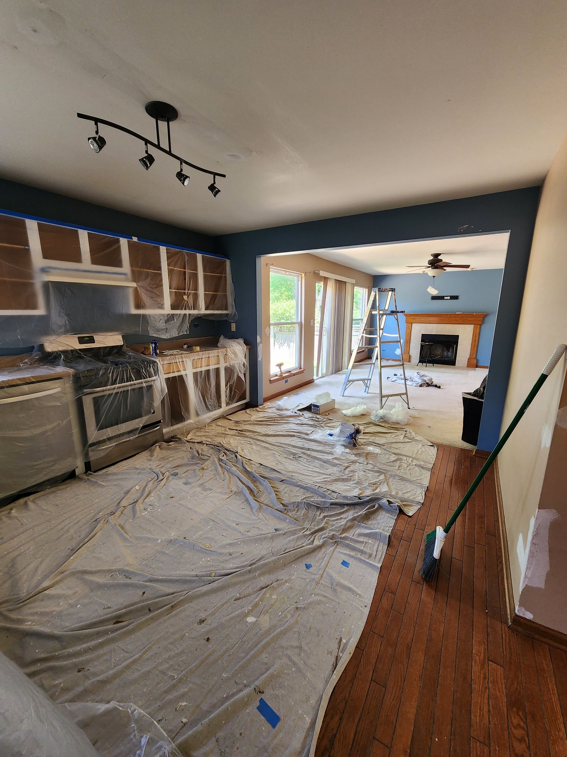 A kitchen is being painted in a house.