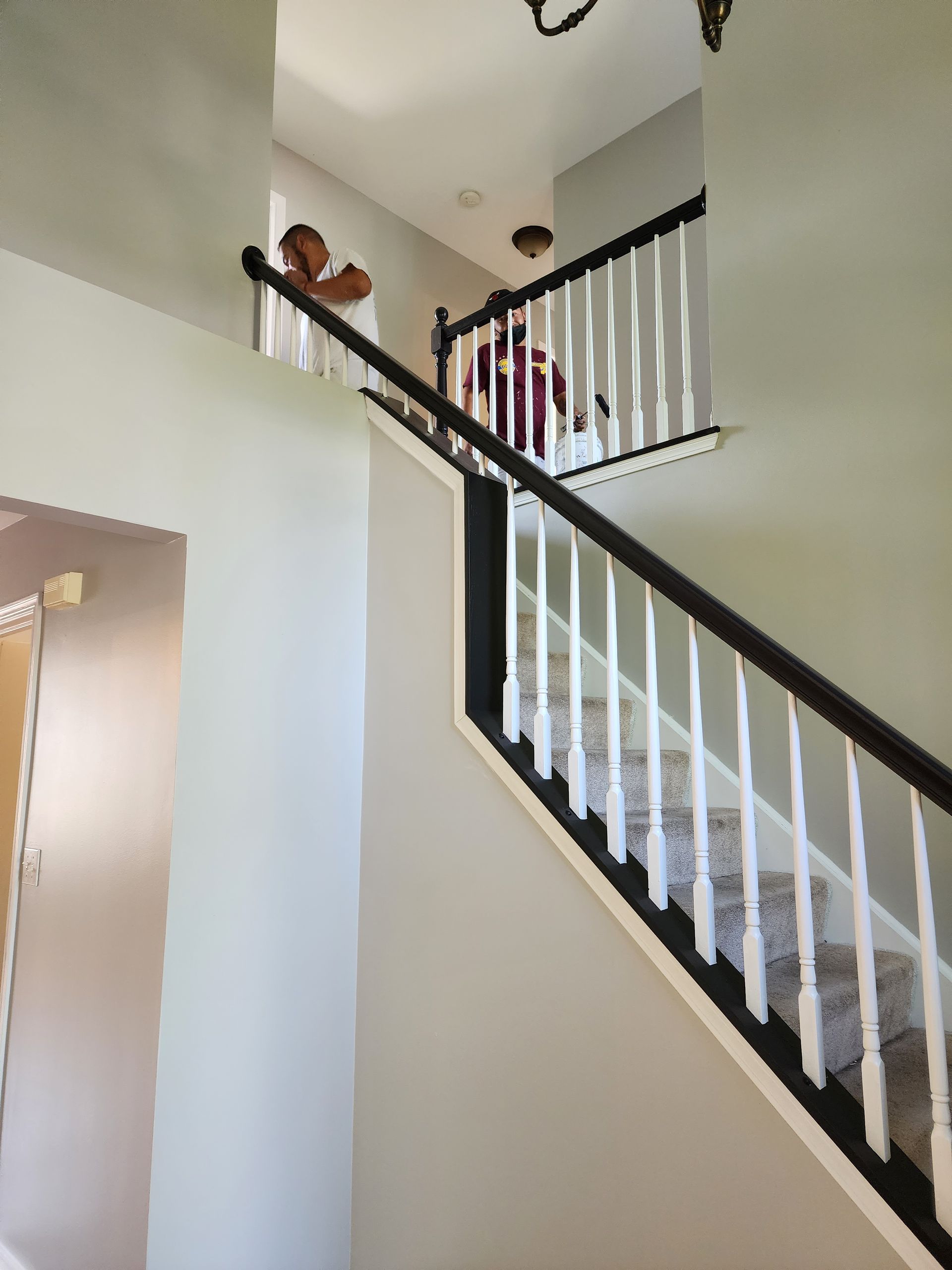 A staircase in a house with a black railing