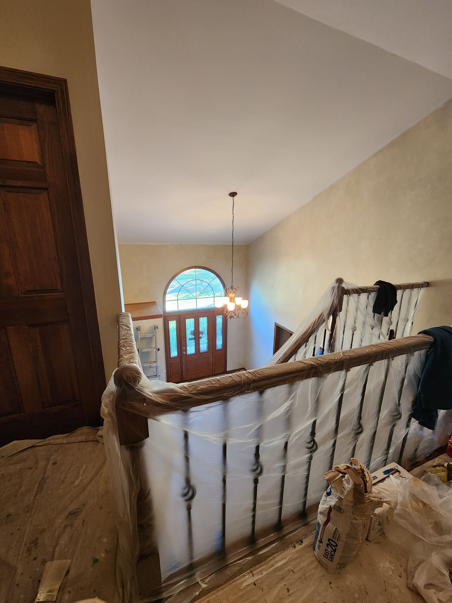 A staircase in a house is being painted.