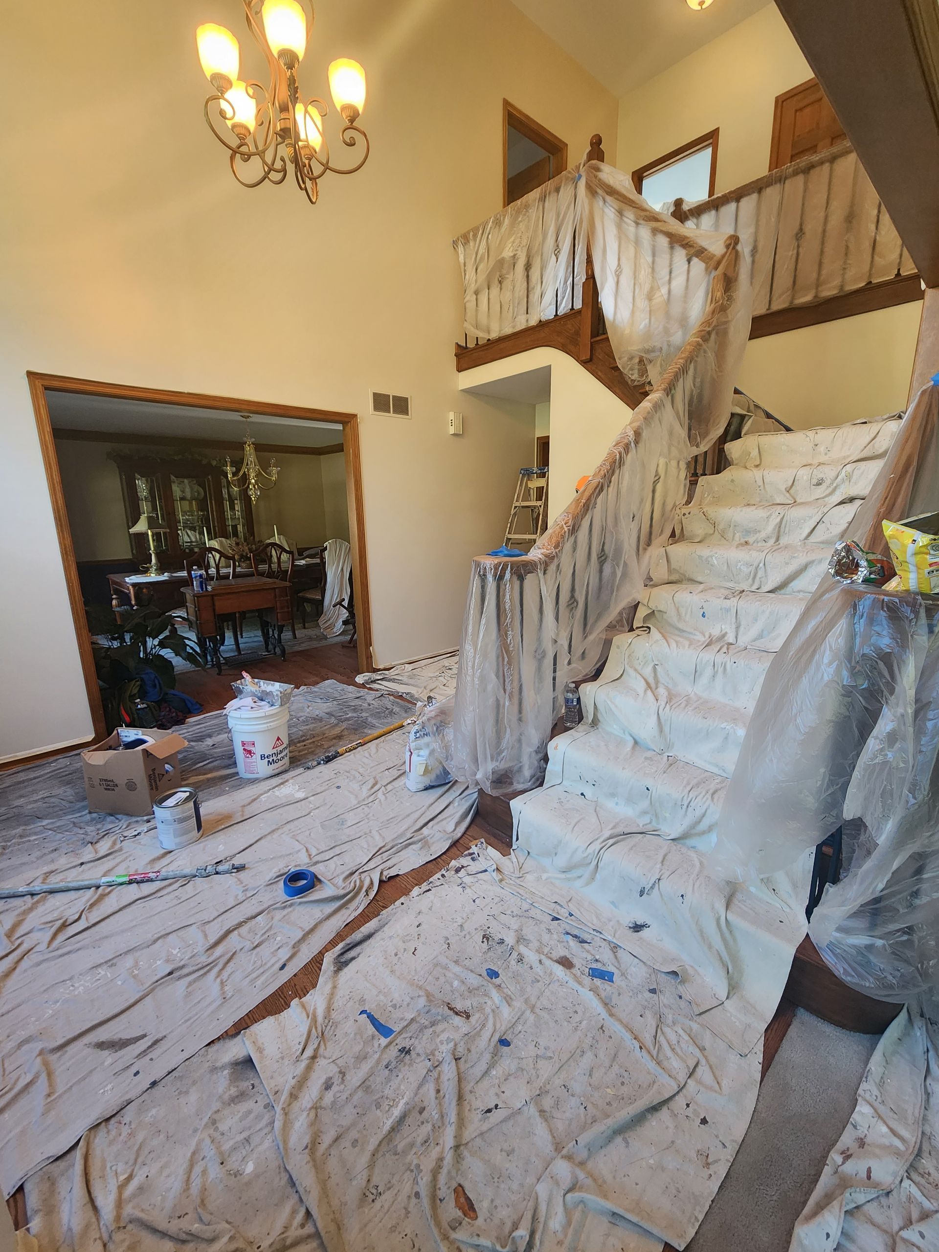 A staircase in a house is being painted.
