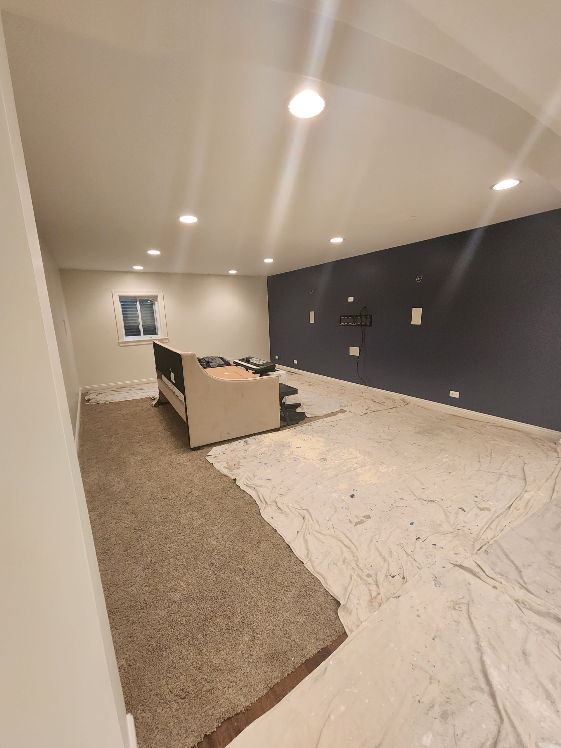 A living room with a couch and a window.