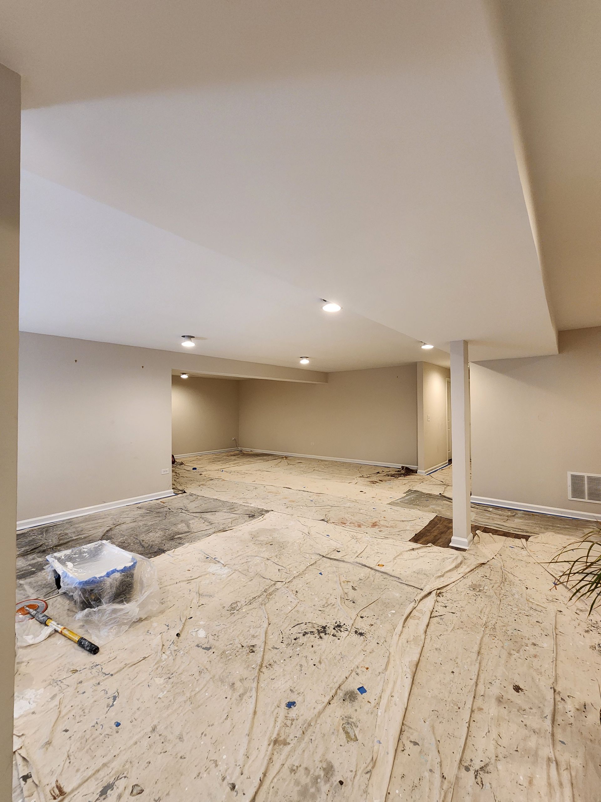 An empty basement with a lot of dirt on the floor.